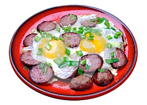 Fried eggs with sausage in a red plate