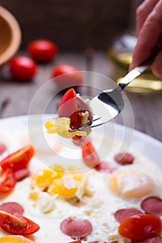 Fried eggs with sausage slices