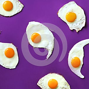 Fried eggs or scrambled eggs pattern on violet background. Creative food concept. Top view. Square crop