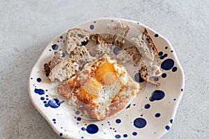 Fried eggs with sesame, served with sour dough toast