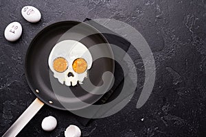 Fried eggs in the shape of a skull. Halloween breakfast.