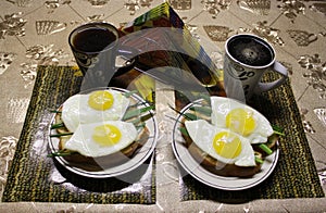 Fried eggs on slices of bread with herbs.