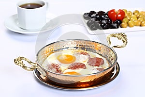 Fried eggs with sucuk on a pan