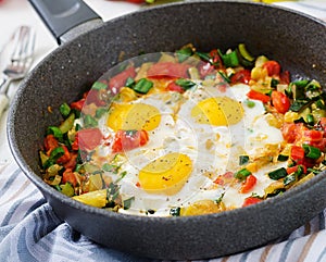 Fried eggs with vegetables. Shakshuka.