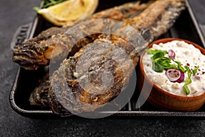 Fried fish Black Sea goby, on a dark background