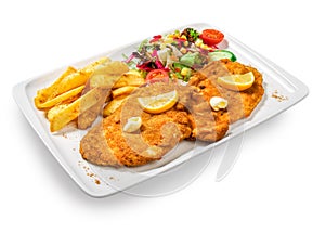 Fried fish in breadcrumbs with potatoes fries and vegetables