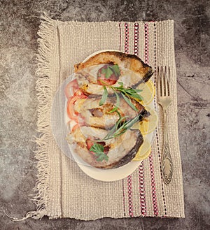 Fried fish carp on the table on a plate