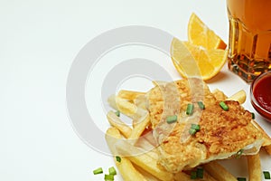 Fried fish and chips, sauces, lemon and beer on white background