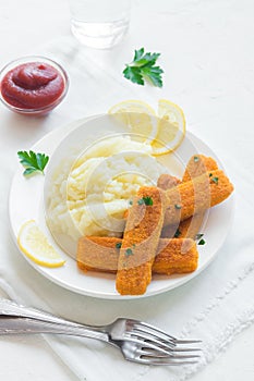 Fried fish fingers, mashed potatoes