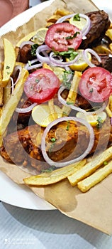 Fried Fish with French Fries, Tomato, Onion and Lemon