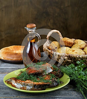 Fried fish with greens and oil