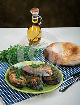 Fried fish with greens and olive oil