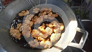 Fried fish patty in boiling oil