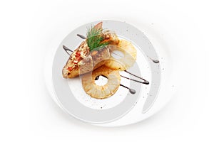 Fried fish with pineapple on white background