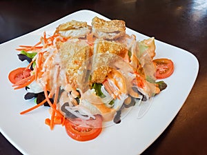 Fried Fish, Salad and Vegetables on Plate, Put on Wood in Restaurant