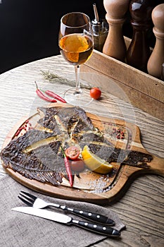 Fried fish served on wooden board at bar