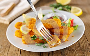 Fried fish sticks with a fork