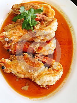 Fried fish in tomato sauce on white plate, Thai food.