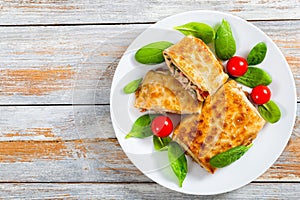 Fried flatbread wraps Stuffed with meat on white dish