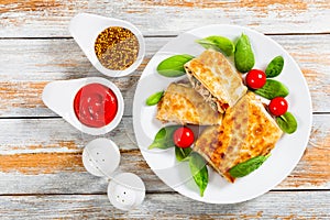 Fried flatbread wraps Stuffed with meat on white dish