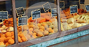 fried foods ideal as street food displayed in the showcase with the name in Italian and the name in American USA photo