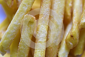 Fried French fries on a white plate close-up