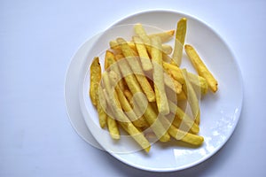 Fried French fries on a white plate close-up