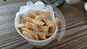 Fried fries on dish menu snack with brown tabel background