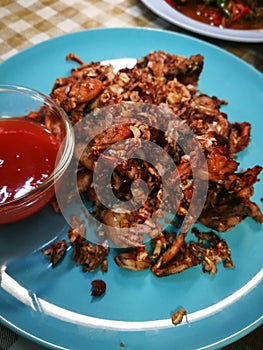Fried Frogs with Salt and Black Pepper. on blue plate