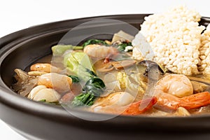 Fried glutinous rice soup with seafood on white background
