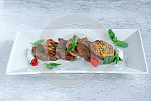 Fried grilled slices of beef fillet with vegetable zucchini and cabbage pancakes
