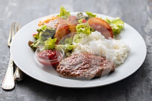 Fried ground meat with tomato sauce and boiled rice on dish