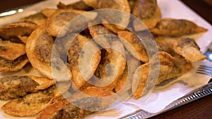 Fried gyoza dumplings with mushroom filling. Golden color hot crunchy dumplings cooked in a pan