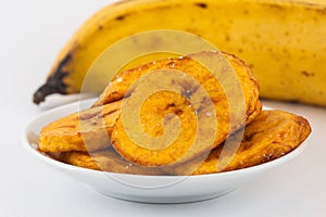 Fried half ripe plantain slices isolated photo