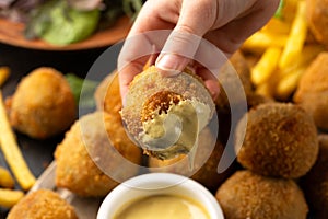 Fried Homemade beef Bitterballen with dijon mustard, ketchup and french fries