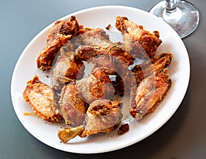 fried hot chicken wings on white plate for brunch