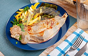 Fried Iberian pig served with potatoes, parsley, stewed pepper