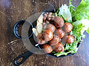 Fried Isaan sausage, set on a plate