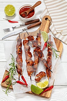 fried juicy pork kebabs on wooden cutting board