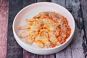 Fried kimji with skinless chicken in korean white plate
