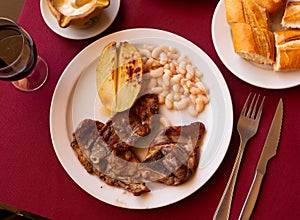 Fried lamb with beans and half potato.