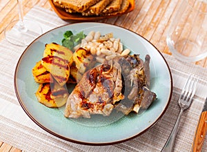 Fried lamb with beans and half potato.