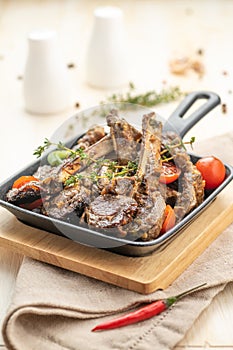 Fried lamb chops with fried onions, garlic and fresh herbs