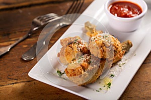 Fried lamb chops in parmesan batter with tomato sauce