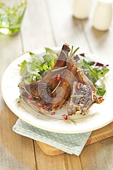 Fried lamb with pomegranate and salad