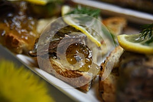 Fried lampreys on a sandwich on a white plate