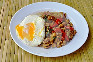Fried large noodle and spicy minced pork with basil leaf topping egg