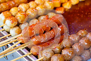 Fried meat balls a grill on a stick in sauce