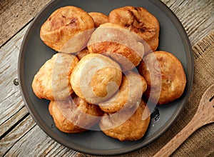 Fried meat pies on dark plate