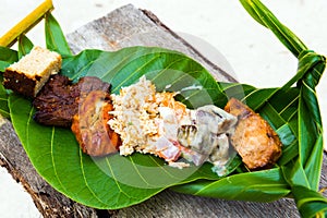 Fried meat with rice on a banana leaf, Bora Bora, French Polynesia. Close-up